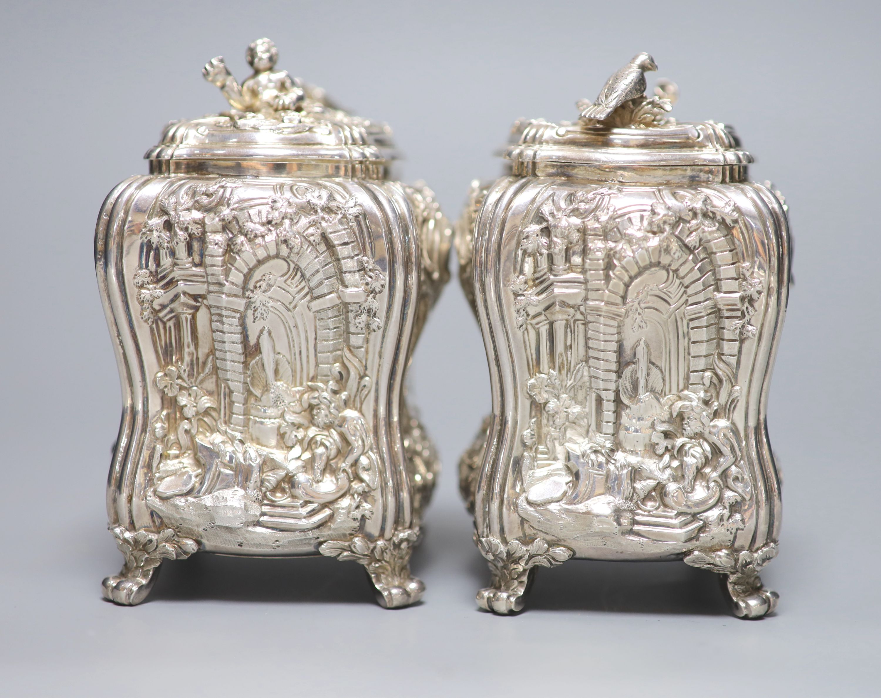 A good pair of George II embossed silver tea caddies and covers, by Elizabeth Godfrey, London, 1749/50, housed in a later 19th century pierced Canton ivory mounted caddy, with velvet interior